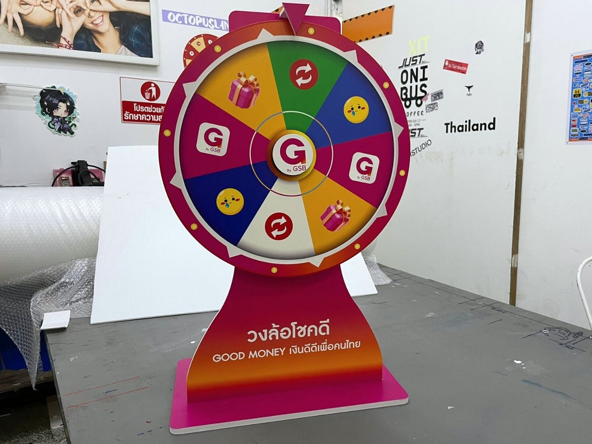 ป้ายหมุนวงล้อขนาดเล็ก สีสันสดใส มีโลโก้ g ตรงกลางและไอคอนของขวัญ