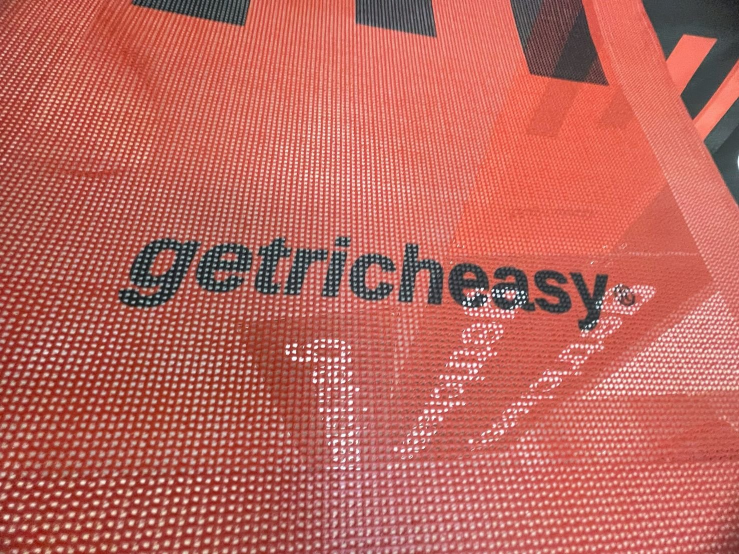 กระเป๋าตาข่ายสีส้มแบรนด์ getricheasy รุ่นป้ายไวนิลตาข่าย