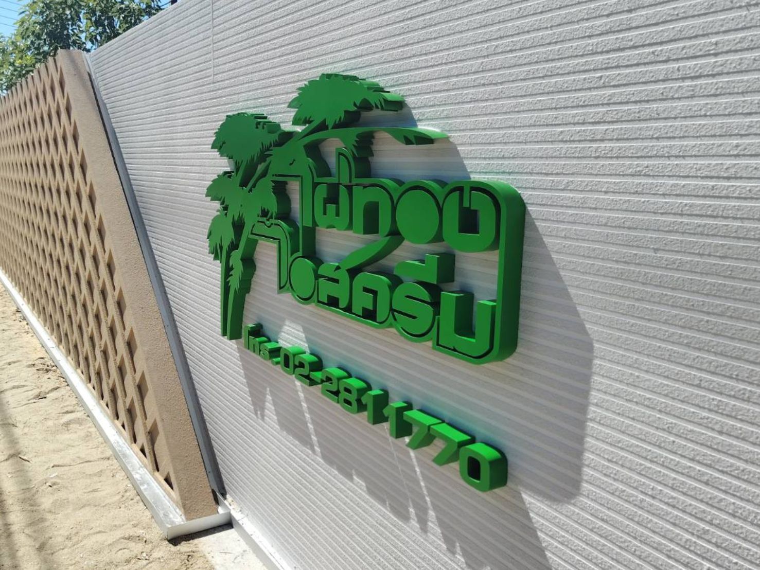 ป้ายอักษรซิงค์ 3 มิติสีเขียวลายต้นปาล์มอักษรไทยบนผนัง