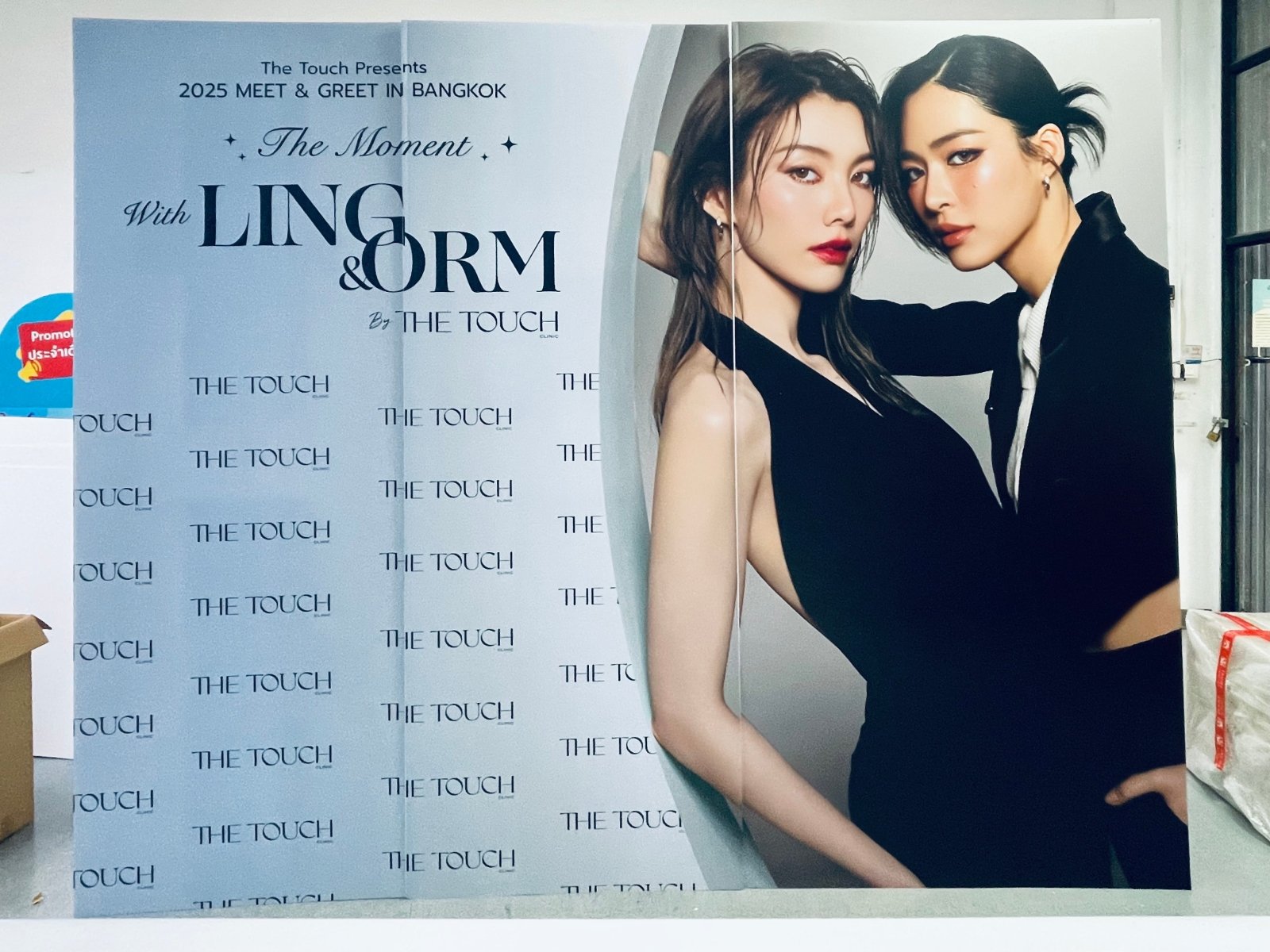 โปสเตอร์โปรโมทสองสาวชุดดำหรู งานพบปะ 2025 by the touch บนแบคดรอป ฟิวเจอร์บอร์ด